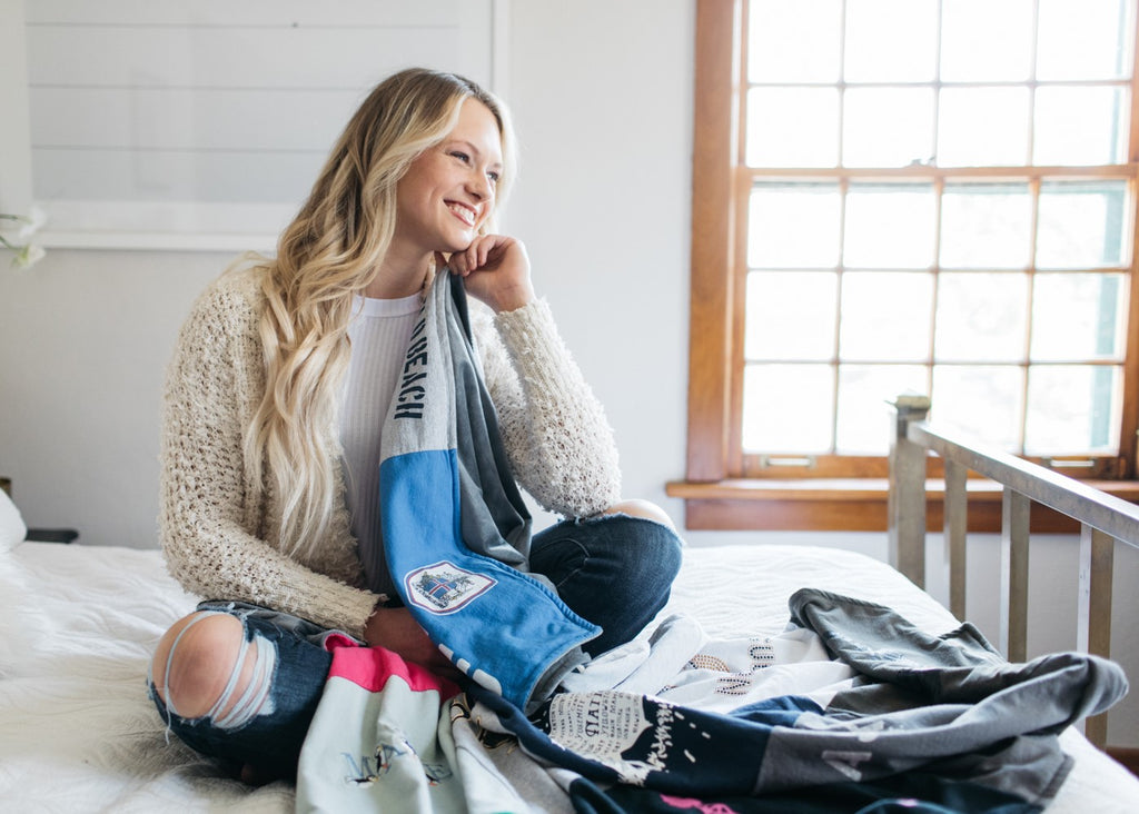 girl on bed with t-shirt quilt