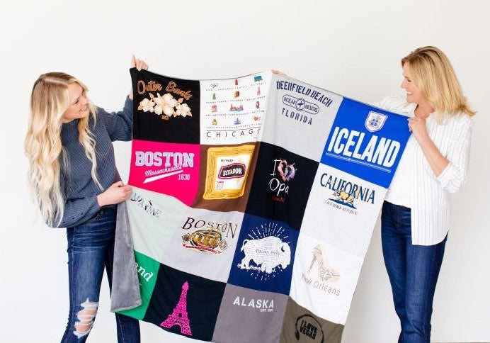 women holding up a t-shirt quilt